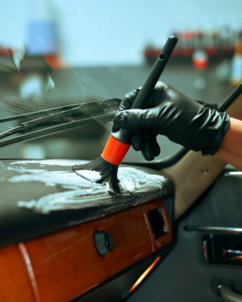 Detailer cleaning the interior of a classic car