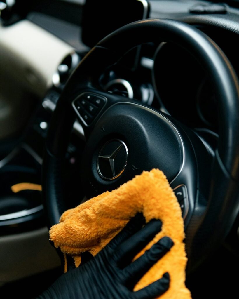 Hand wiping paint after a clay and sealant treatment